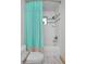 Cozy bathroom featuring a tub with shower, bright curtain and modern fixtures at 14370 Osage St, Westminster, CO 80023
