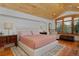 Comfortable bedroom with wooden ceiling, large bed, and a shuttered window at 14370 Osage St, Westminster, CO 80023
