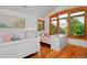 Charming bedroom with twin beds, crisp white furniture, hardwood floors, and shuttered windows at 14370 Osage St, Westminster, CO 80023