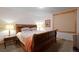 Comfortable bedroom with wood frame bed, side tables, and natural light at 14370 Osage St, Westminster, CO 80023