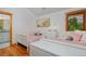 Bright bedroom with twin beds, crisp white furniture, hardwood floors, and shuttered windows at 14370 Osage St, Westminster, CO 80023
