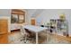 Bonus room featuring a large white table, study chairs, natural light, and built in bookshelves at 14370 Osage St, Westminster, CO 80023