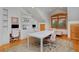 Bright bonus room with desks, chairs, and a large table for activities at 14370 Osage St, Westminster, CO 80023