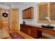 Welcoming entryway with wood accents and built-in desk and cabinets at 14370 Osage St, Westminster, CO 80023