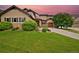Charming two-story home with a lush green lawn and mature tree, offering curb appeal and a welcoming atmosphere at 14370 Osage St, Westminster, CO 80023