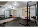 Home gym featuring a variety of equipment, large mirror and weights at 14370 Osage St, Westminster, CO 80023