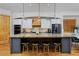 Gourmet kitchen features an expansive island, stainless steel appliances, pendant lights, and counter seating at 14370 Osage St, Westminster, CO 80023