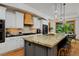 Gourmet kitchen features granite countertops, stainless steel appliances, and a large island with seating at 14370 Osage St, Westminster, CO 80023