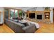 Bright living room with hardwood floors, a stone fireplace, and large windows, creating a warm, inviting atmosphere at 14370 Osage St, Westminster, CO 80023