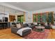 Spacious living room with hardwood floors, a large sectional sofa, and bright windows, perfect for entertaining at 14370 Osage St, Westminster, CO 80023