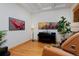 Cozy living room featuring hardwood floors, decorative artwork, and a sleek black piano, perfect for relaxation at 14370 Osage St, Westminster, CO 80023
