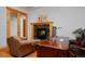 Office with fireplace, wooden desk, and comfortable seating at 14370 Osage St, Westminster, CO 80023