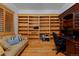 Office with custom wooden built-ins, desk, and comfortable seating area at 14370 Osage St, Westminster, CO 80023