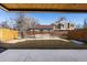 Back yard view from covered patio, showing the lawn, modern fencing, and view of the neighborhood at 2160 Folsom St, Boulder, CO 80302