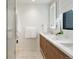 Modern bathroom features double sink vanity, LED mirror, tiled shower, and floating shelves for stylish storage at 2160 Folsom St, Boulder, CO 80302