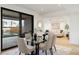 Bright dining room with a glass table and chairs has a view of the outdoor space and the living room at 2160 Folsom St, Boulder, CO 80302