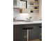 Close-up on kitchen island with marble counters, modern faucet, and open shelving at 2160 Folsom St, Boulder, CO 80302