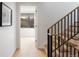Modern staircase features wooden steps and black metal railings, leading to the upper level of the home at 2160 Folsom St, Boulder, CO 80302