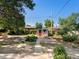 The spacious backyard features a shed with a red door and various garden plots at 14050 E 25Th Pl, Aurora, CO 80011