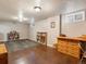 Finished basement featuring large area rug, bookshelves, and a work/craft space at 14050 E 25Th Pl, Aurora, CO 80011