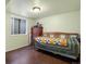 This bedroom includes a large window, hard surface flooring, and comfortable single bed at 14050 E 25Th Pl, Aurora, CO 80011
