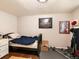 A cluttered bedroom with basic furnishings, a bed, and exercise equipment at 14050 E 25Th Pl, Aurora, CO 80011