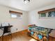 Bright bedroom featuring hardwood floors, natural light, and a cozy bed at 14050 E 25Th Pl, Aurora, CO 80011