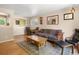 Inviting living space featuring hardwood floors, neutral walls, and comfortable seating, ideal for relaxation and gatherings at 14050 E 25Th Pl, Aurora, CO 80011