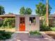 Backyard shed with red door, potting table and a brick patio and garden at 14050 E 25Th Pl, Aurora, CO 80011