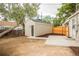 Backyard featuring a shed with concrete patio, wooden fence, and low maintenance yard at 2696 S Grove St, Denver, CO 80219