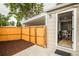 Cozy fenced backyard featuring modern gray house exterior with white trim and updated patio at 2696 S Grove St, Denver, CO 80219