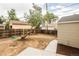 Spacious backyard with a wooden fence, shed, and ample space for gardening or outdoor activities at 2696 S Grove St, Denver, CO 80219