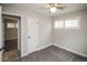 Well-lit bedroom with carpet, a ceiling fan, and a view into an adjacent room at 2696 S Grove St, Denver, CO 80219