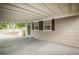 Welcoming carport featuring a covered entrance and stylish front door with adjacent window at 2696 S Grove St, Denver, CO 80219