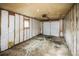 Spacious garage interior with a clean, unfinished look, exposed insulation, and concrete floor at 2696 S Grove St, Denver, CO 80219