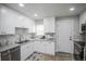 Updated kitchen featuring bright white cabinets and modern appliances at 2696 S Grove St, Denver, CO 80219
