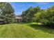 Expansive backyard with mature trees offering shade and a well-maintained lawn, perfect for outdoor activities at 16326 E Dorado Ave, Centennial, CO 80015