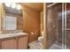 Bathroom featuring a glass-enclosed tiled shower, vanity with sink, and toilet with a tiled floor at 16326 E Dorado Ave, Centennial, CO 80015