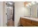 Bathroom with oak vanity and mirror and view into adjacent bathroom at 16326 E Dorado Ave, Centennial, CO 80015