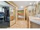 Spacious bathroom features dual vanities, a soaking tub, walk-in closet and tile flooring at 16326 E Dorado Ave, Centennial, CO 80015