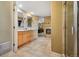 Bright bathroom with dual vanities, tiled floors, and a glass-enclosed shower at 16326 E Dorado Ave, Centennial, CO 80015