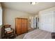 Comfortable bedroom with carpet, wooden wardrobe, and a decorative chair at 16326 E Dorado Ave, Centennial, CO 80015