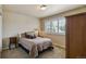 Cozy bedroom with plush carpet, neutral tones, and a bright window with shutters at 16326 E Dorado Ave, Centennial, CO 80015