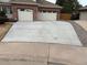 Wide concrete driveway leading to a two-car garage of a brick home at 16326 E Dorado Ave, Centennial, CO 80015
