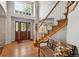 Inviting foyer with hardwood floors, a staircase, a bench, and a high window allowing natural light at 16326 E Dorado Ave, Centennial, CO 80015