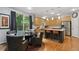 Open-concept kitchen with an island, stainless steel appliances, wooden floors, and dining area at 16326 E Dorado Ave, Centennial, CO 80015