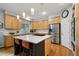 Kitchen featuring an island with seating, stainless steel appliances, and plenty of cabinet space at 16326 E Dorado Ave, Centennial, CO 80015