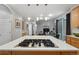 View from a kitchen island cooktop into an open living space with natural light at 16326 E Dorado Ave, Centennial, CO 80015