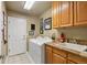 Functional laundry room features a washing machine, dryer, sink, and ample storage at 16326 E Dorado Ave, Centennial, CO 80015