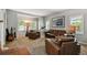 Bright living room featuring leather seating, a telescope, and shuttered windows for natural light at 16326 E Dorado Ave, Centennial, CO 80015